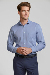 A men's long sleeve button-up shirt in light blue, featuring a chest pocket and a logo on the chest.