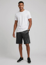 A model wearing black sports shorts and a plain white t-shirt, standing against a neutral background.