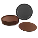 A set of six leather coasters in brown and black, stored in a round holder with stitching detail.