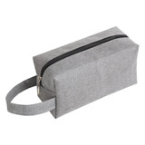 A grey nylon cosmetic bag with a zip closure and a convenient handle on the side.