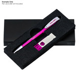 A pink pen and a sharpener are displayed in a black gift box with a fitted foam insert. The box has a branding logo.