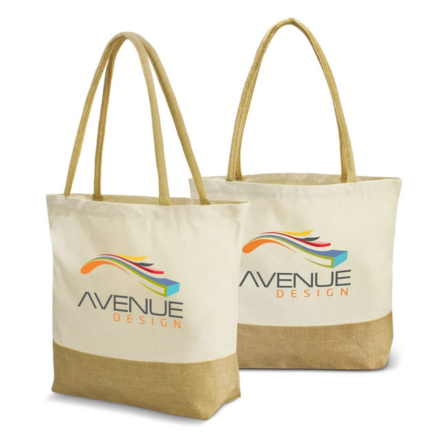 A cream tote bag with a brown base and long handles, featuring a logo on one side.