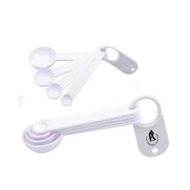A set of white measuring scoops in various sizes, joined by a ring, with a logo on one scoop.