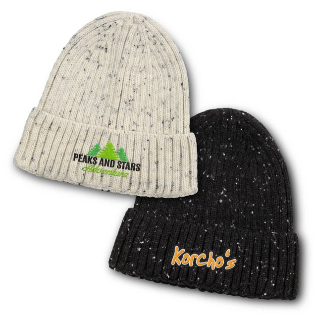 A snowflake beanie, featuring a cream and black colour scheme, with logos on the front of each hat.