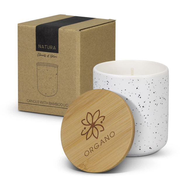 NATURA candle in a white speckled container with a bamboo lid, accompanied by a recyclable cardboard box.