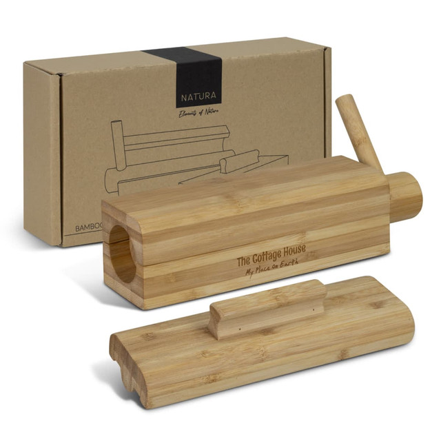 A bamboo sushi maker with a wooden lid and a removable piece, presented with a decorative box.