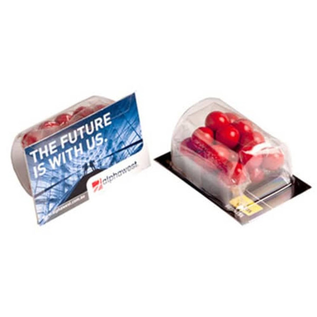 A transparent container filled with orange chocolate drops, accompanied by a branded packaging.