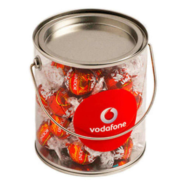 A big silver PVC bucket filled with red-wrapped Lindt chocolate balls, featuring a logo on the front.