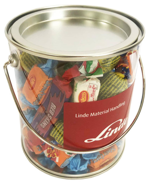 A clear PVC bucket filled with colourful Allen's lollies, featuring a metal handle and a red branding label.