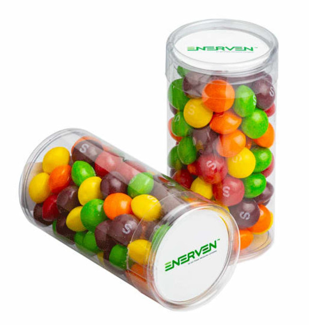 Two clear tubes filled with colourful Skittles in red, green, yellow, orange, and purple, featuring a branding logo.