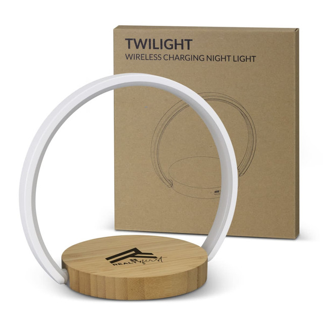 A wireless charging night light with a wooden base and a white ring, next to a plain cardboard box featuring a logo.
