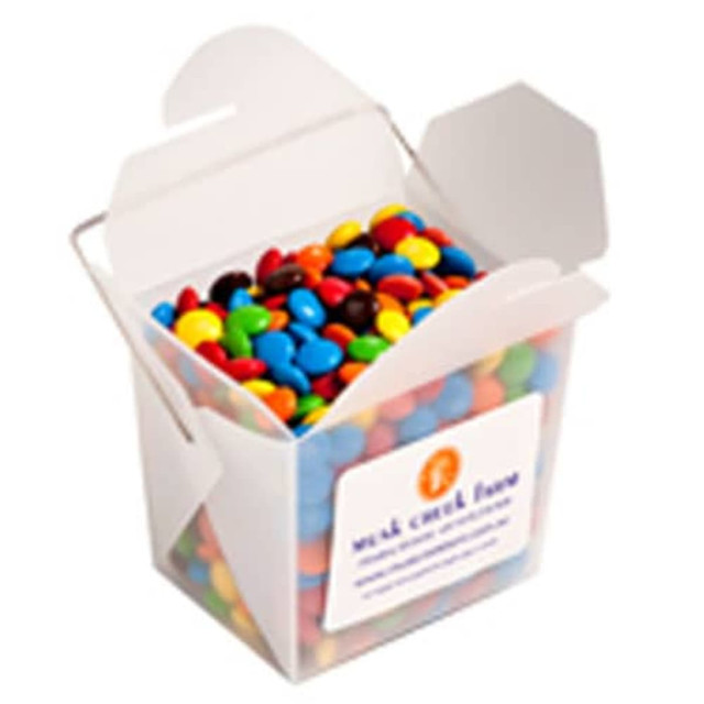 A frosted noodle box filled with colourful chocolate beans, featuring various shades of red, blue, yellow, green, and brown.