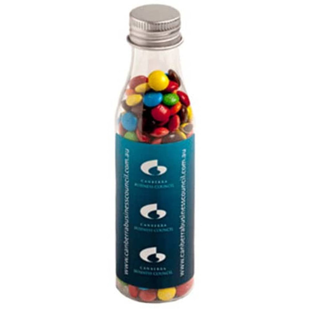 A drink bottle filled with colourful M&Ms, featuring a silver lid and a branded label.