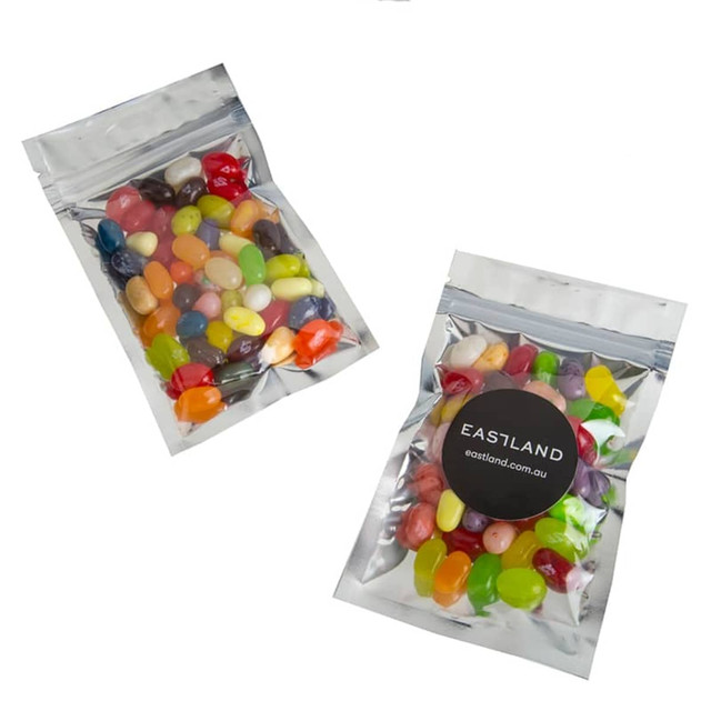 A silver zip lock bag containing various colourful JELLY BELLY jelly beans, featuring a logo on the front.