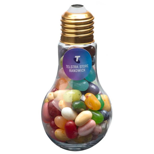 A glass light bulb filled with colourful jelly beans, featuring a golden cap and a logo.