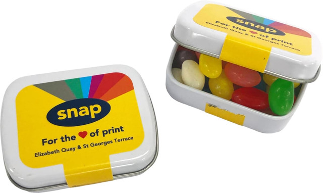 A small rectangular tin filled with colourful mini jelly beans, featuring a lid with a logo and vibrant design.