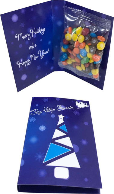 A gift card with a 25g bag of colourful M&M chocolates inside a festive blue card. The card features a Christmas tree design.