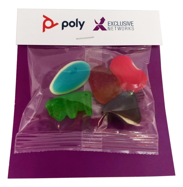 A bag containing mixed lollies in various shapes and colours, including blue, green, red, and purple. It has branding.