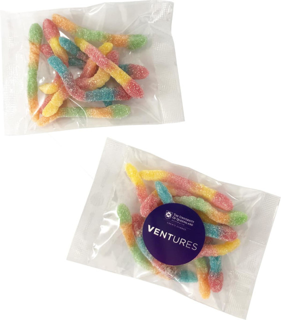 A packet of colourful gummy sour worms in pink, yellow, blue, and green, with a logo on the packaging.