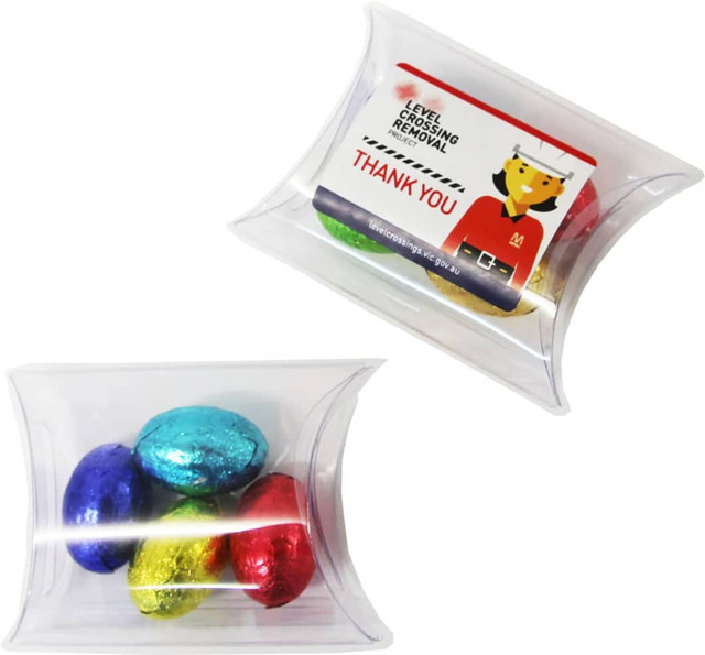A pillow pack containing four mini solid Easter eggs in blue, red, green, and yellow, with a branded tag.