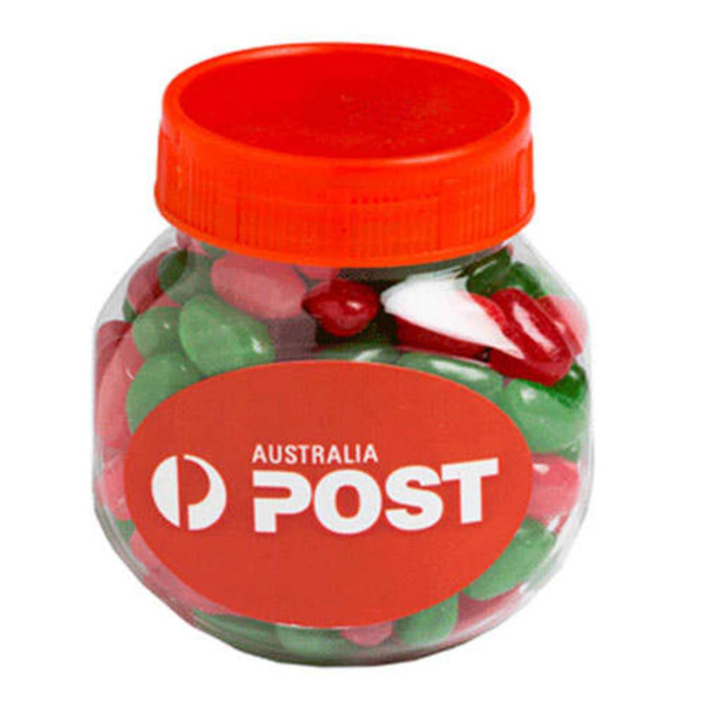 A clear plastic jar filled with red, white, and green jelly beans, topped with an orange lid.
