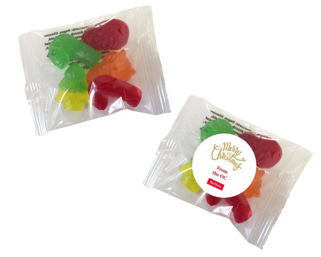 A packet of Christmas mixed lollies featuring red, green, yellow, and orange gummy shapes, with a logo visible.