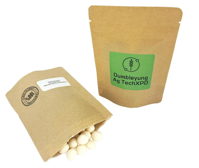 A compostable bag containing chewy mints, featuring a natural brown colour and a green logo.