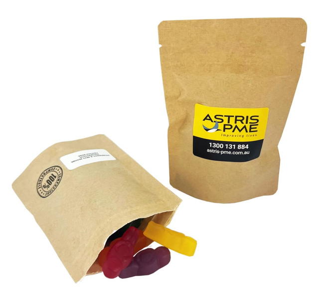 A compostable bag containing assorted colourful jelly babies, featuring a logo on the packaging.