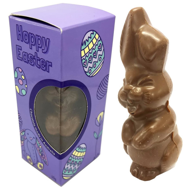 A chocolate Easter bunny in a purple branded box, decorated with colourful egg patterns.