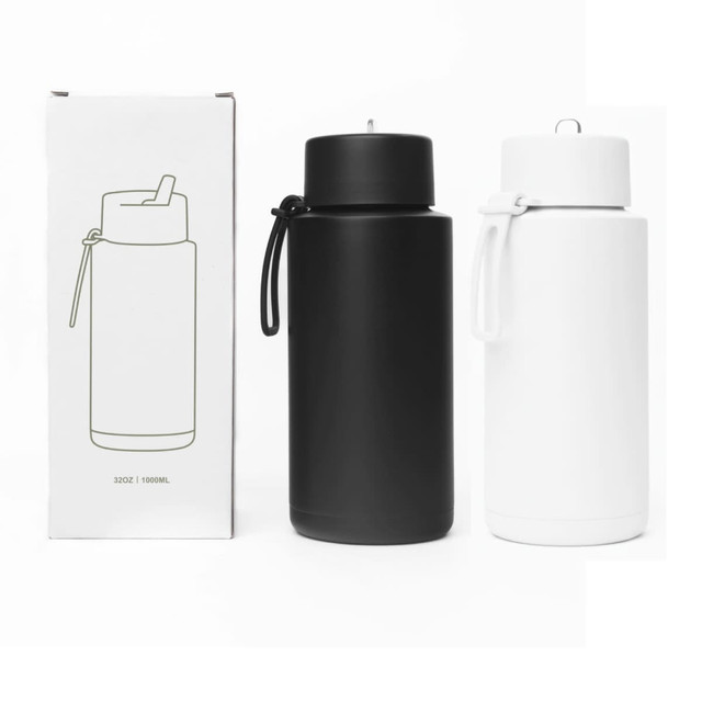 A drink bottle set featuring a black and a white 1L stainless steel bottle with silicone handles, packaged in a box.