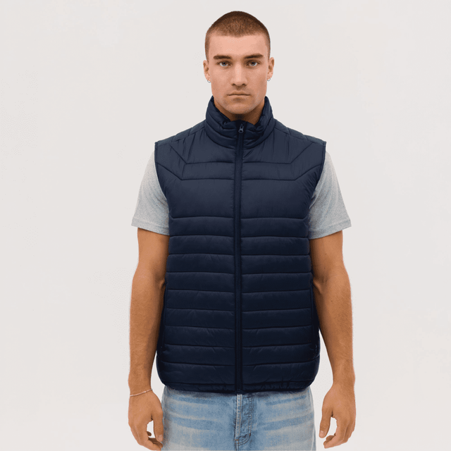 A navy blue puffer vest with a zip front, featuring a high collar and a simple design, on a model.