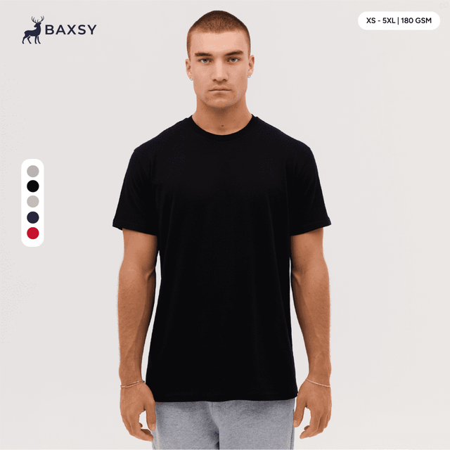 A black T-shirt featuring a classic fit, with a logo present, displayed on a model against a neutral background.