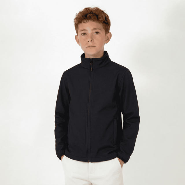 A youth softshell jacket in navy, featuring a zip front and a high collar. Includes a logo on the jacket.