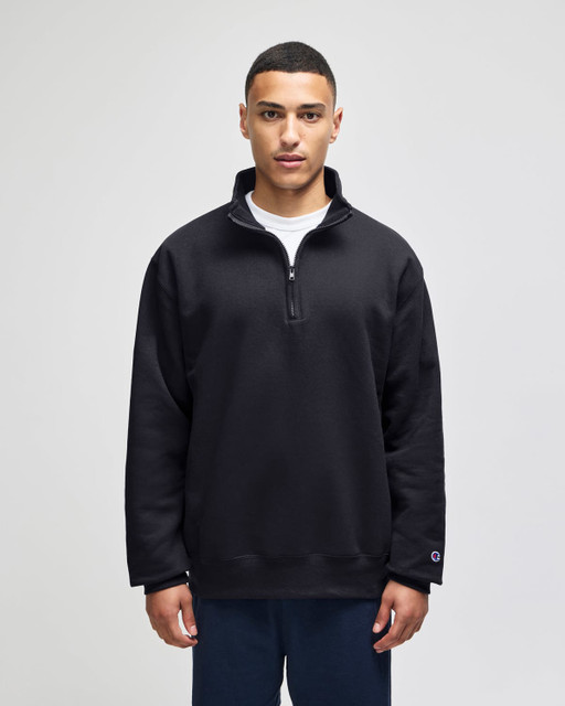 A black quarter-zip pullover with a relaxed fit, featuring a collar and a logo on the sleeve.