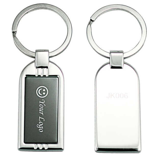 A silver keyring with a rectangular design featuring a logo area and a smooth back side.