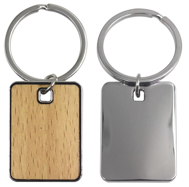A keyring featuring a rectangular design with one side wooden and the other metallic, attached to a silver ring.