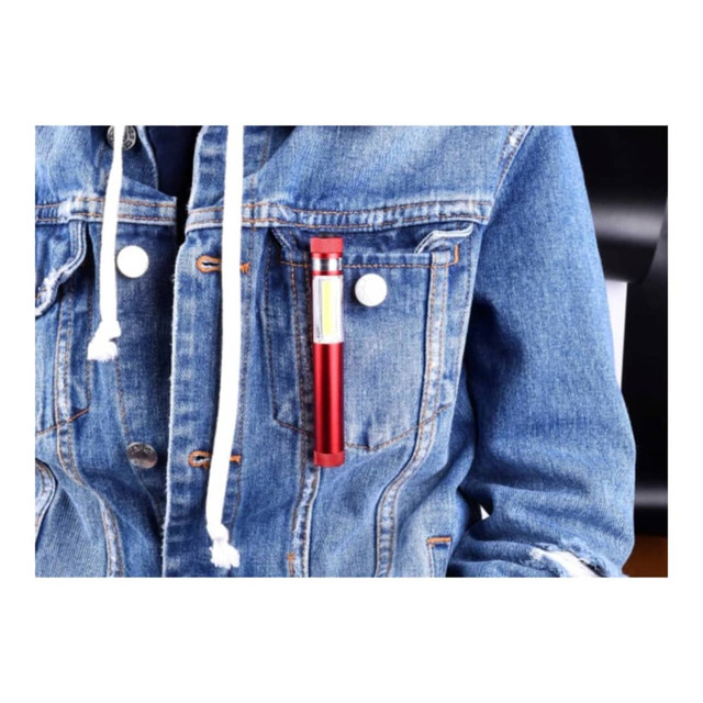 A drink bottle in a red finish, positioned in the pocket of a denim jacket. The bottle features a logo.