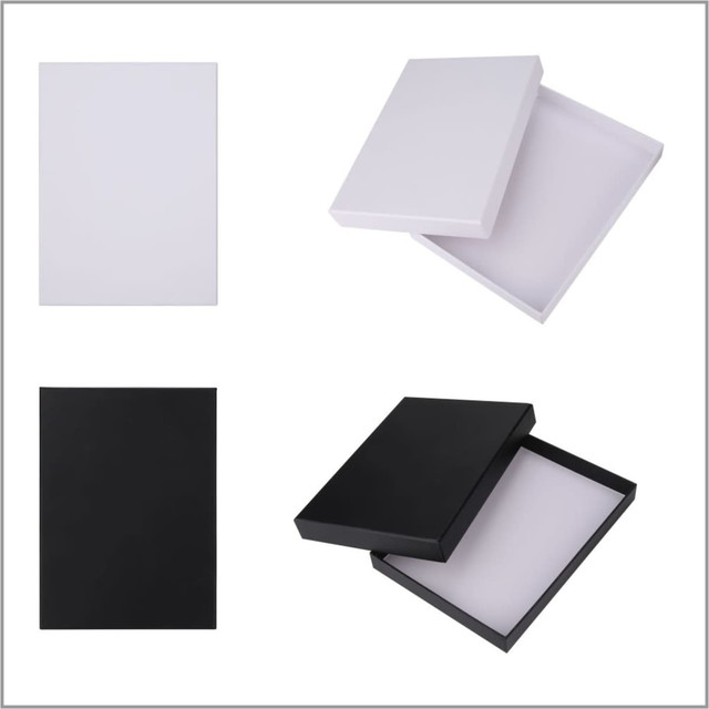 A set of four gift boxes in white and black, featuring both open and closed views. Each box has a simple design.