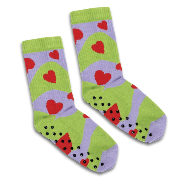 Bright green and lavender socks featuring red hearts and black non-slip grips on the soles, with a playful design.