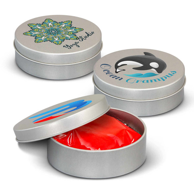 Three silver tins of stress putty, with colourful designs on the lids, showcasing red putty inside one of the tins.