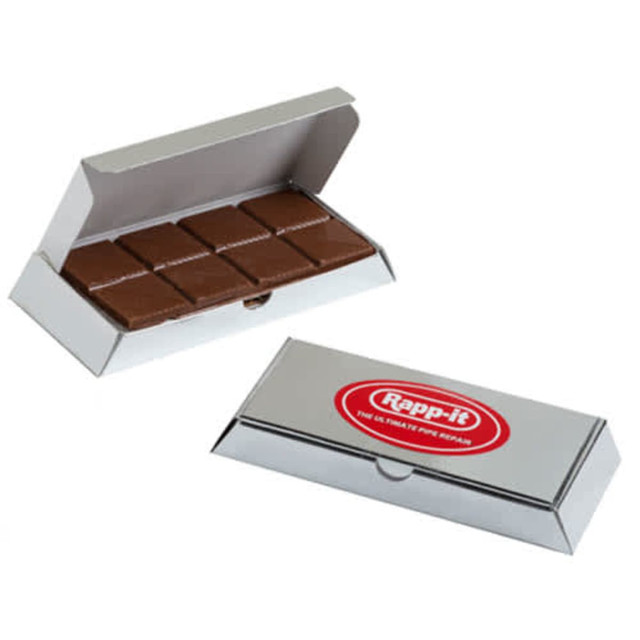 A milk chocolate bar in a silver branded box, featuring two layers of chocolate, neatly arranged inside.