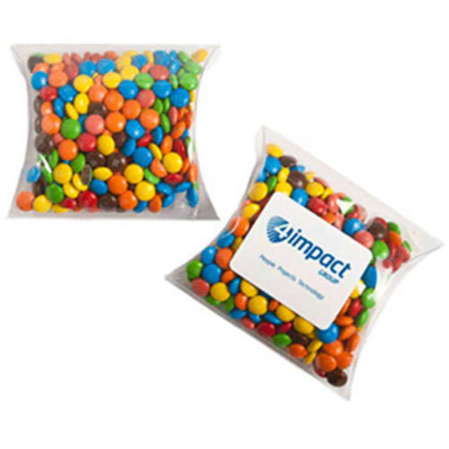 A pillow pack filled with assorted chocolate-coated candies in various colours, featuring a logo on the packaging.