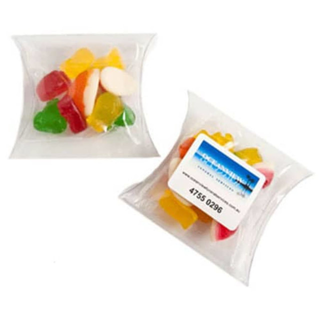 A pillow pack filled with assorted mixed lollies in bright colours, including red, yellow, green, and white.