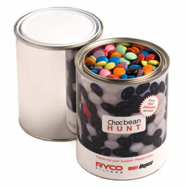 A silver paint tin filled with colourful choc beans, featuring a branded wrapper.