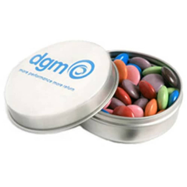 A silver tin filled with colourful choc beans, featuring a branded logo on the lid.