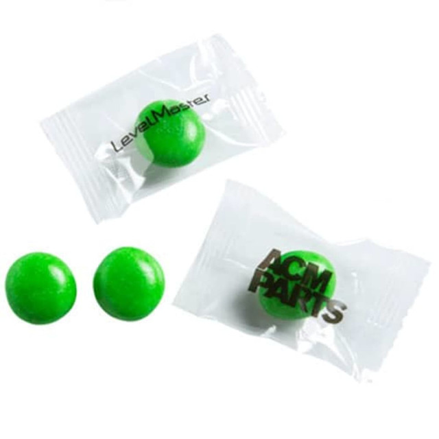 Individually wrapped green chewy fruit candies in unbranded packaging, featuring two green candies visible.