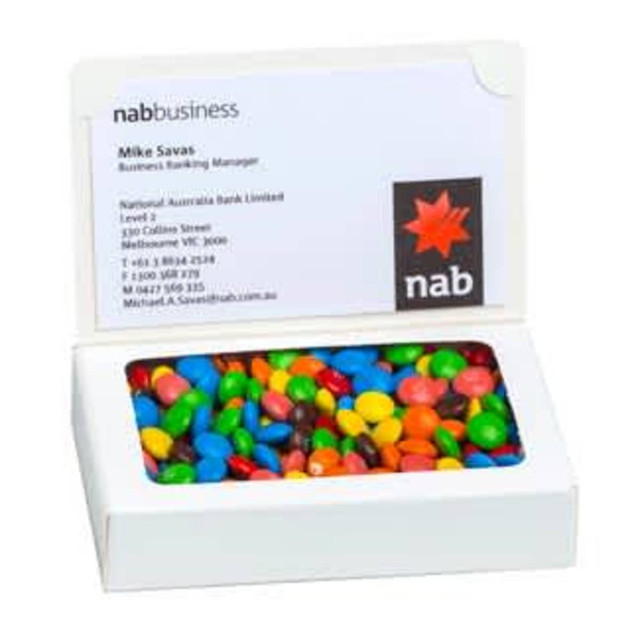 A white box containing colourful choc beans, featuring a logo on the front.