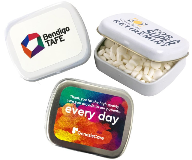 Small rectangular tin featuring white mints, with a logo and a colourful design on the lid.