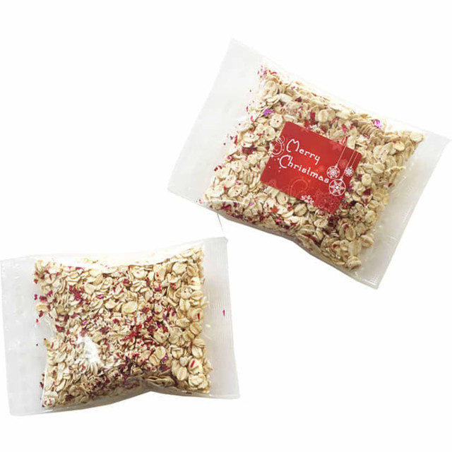 A resealable pouch containing a mix of oats with red and white decorative sprinkles, featuring a branded label.