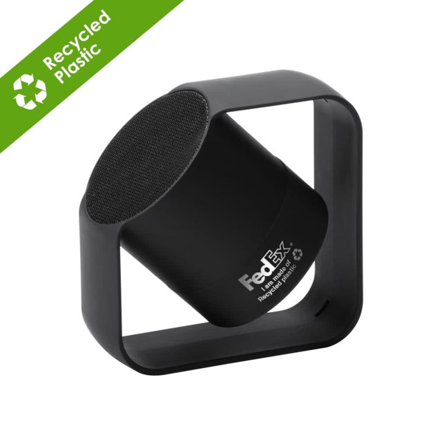 A black wireless speaker made from recycled ABS and aluminium, featuring a square base and a round speaker section.